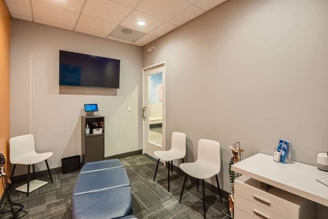 Private consultation room with chairs and screen